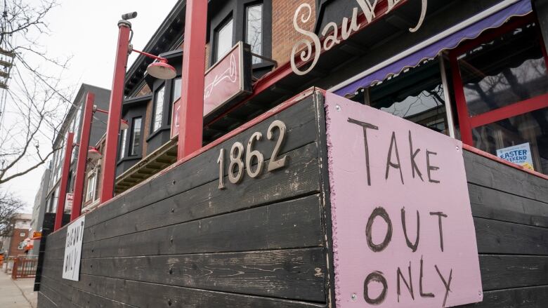 A restaurant patio displays a sign that reads 