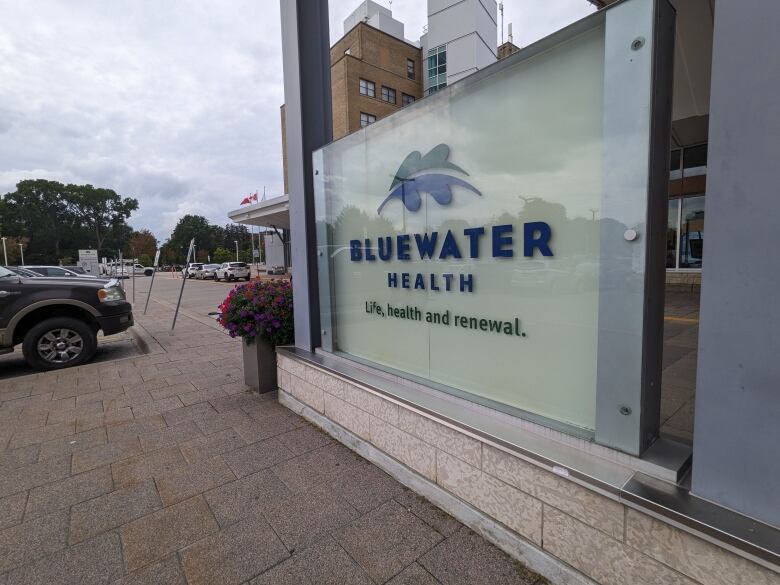 A photo of a window with the Bluewater health logo