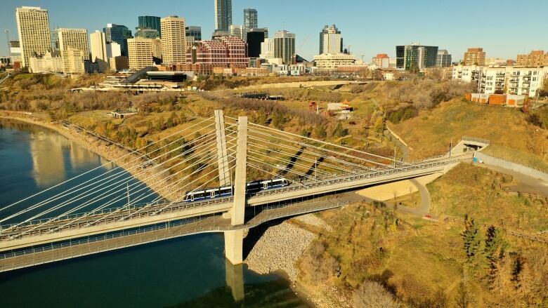 Valley Line LRT crosses over bridge across the North Saskatchewan river.