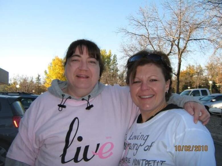 Two women at a breast cancer awareness event. 