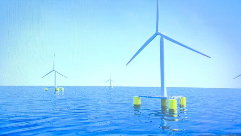 A wind turbine stands tall in a body of water.