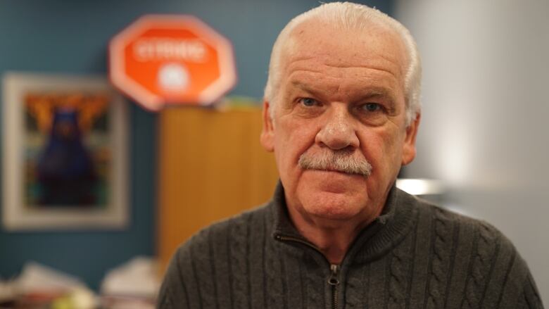 A union leader poses for a photo in an office.