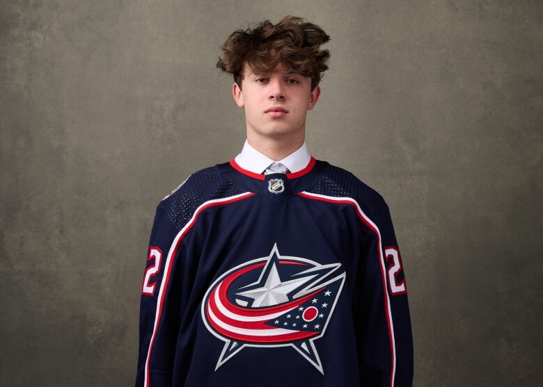 A teenage hockey player looks directly at the camera in a portrait taken after he was drafted by the NHL's Columbus Blue Jackets.