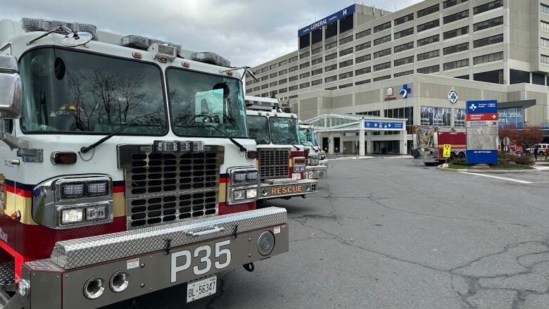 Several fire trucks parked outside of the Ottawa Hospital's General campus. 