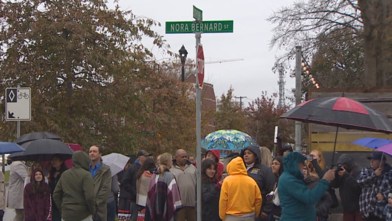 A crowd of people stand near the street now known as Nora Bernard Street in Halifax. 