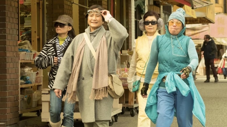 From left, Sharmaine Yeoh, Pei-Pei Cheng, Alannah Ong and Lillian Lim in the film Meditation Park. They're dressed for cold weather, walking on a city sidewalk. 