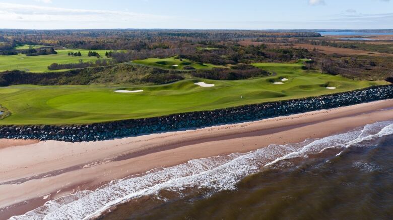 A drone view of the shoreline along a golf course 