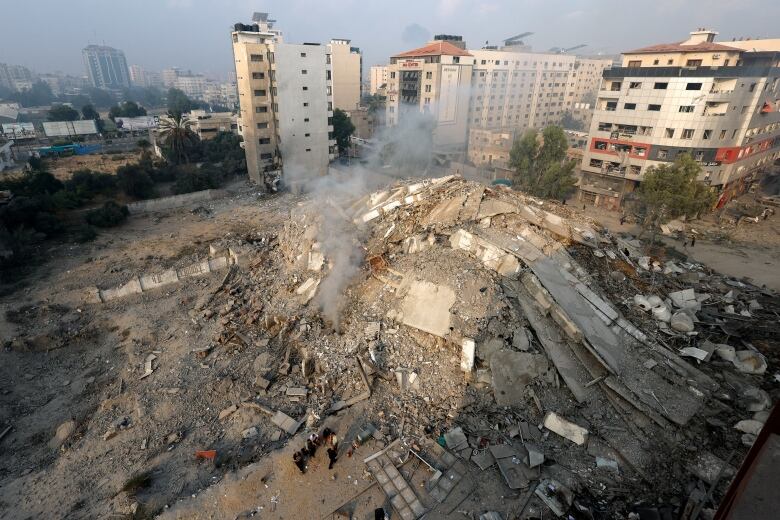 A bird's-eye wideshot of the Watan Tower building destroyed by Israeli airstrikes in Gaza City.