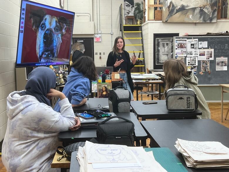 Woman speaking to class.