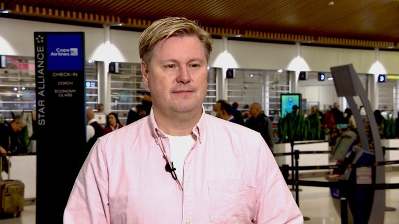 A man is interviewed at Pearson airport in Toronto.