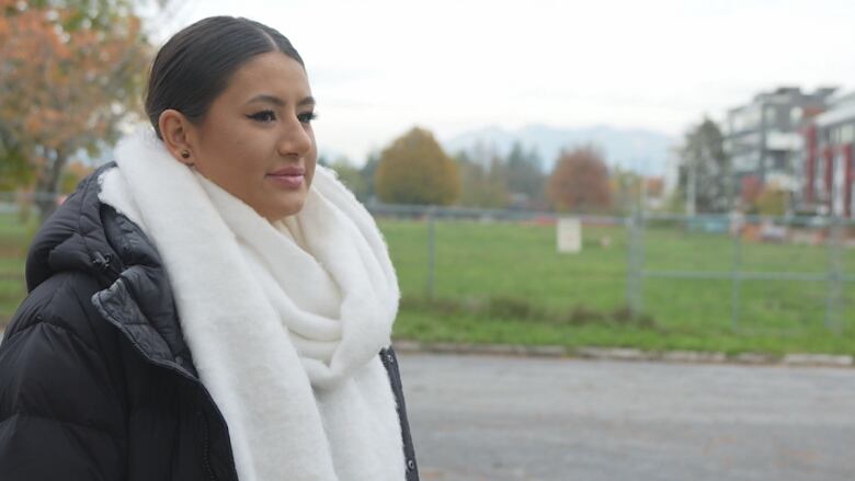 Profile shot of a woman in jacket and white wool scraf