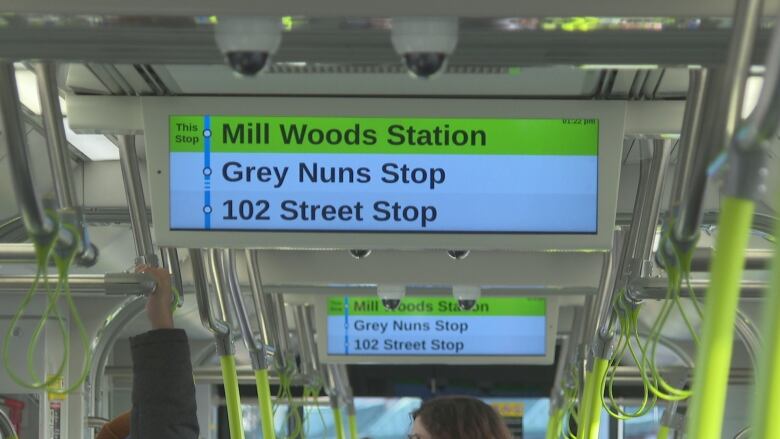 A digital sign with train stops