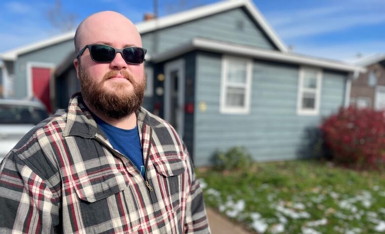 A man outdoors, wearing sunglasses.