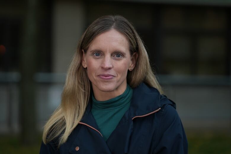 Woman in a navy blue coat.