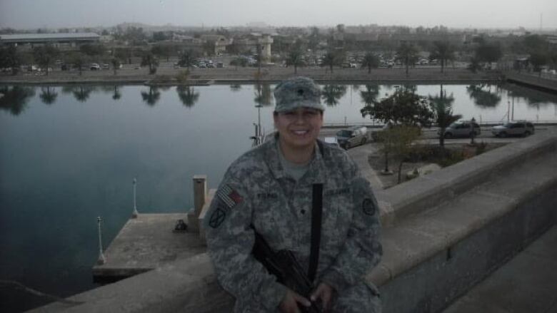 An Indigenous woman in army fatigues in Iraq. 