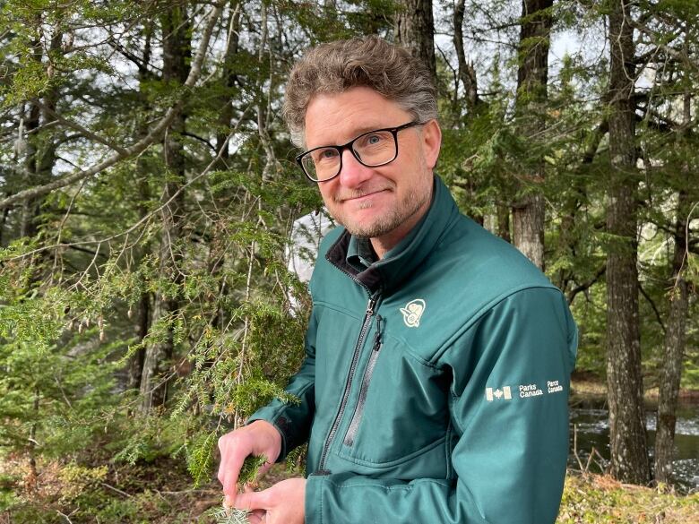 A man wearing a green Parks Canada coat 