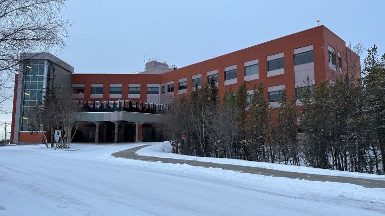 An institutional building is seen from the outside in winter.