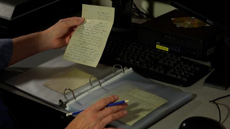 Stephen Davies holds a letter written by a soldier to his sister back home, an example of the work he is digitizing. 