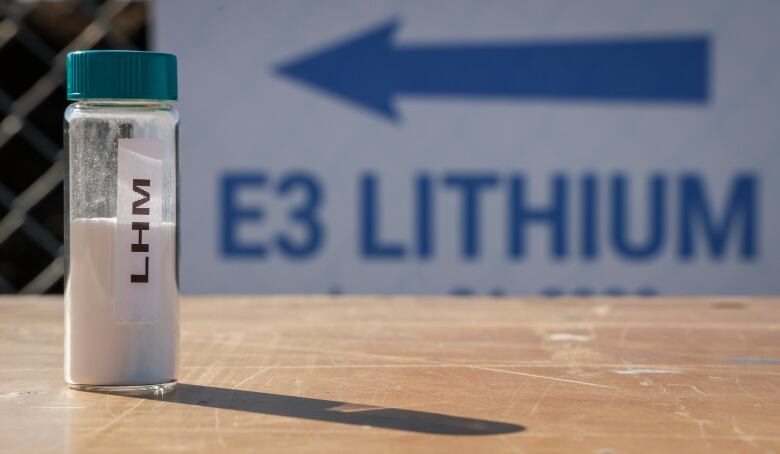 A picture depicting a vile of lithium is shown with a sign that reads E3 in the background.