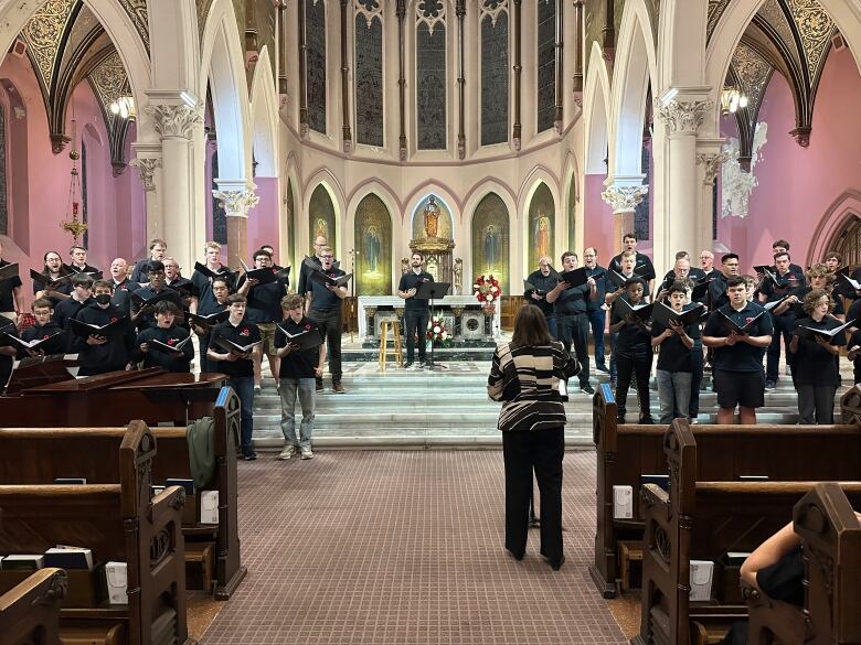 Performers with the Amabile Choirs of London, Ontario are rehearsing for the Nov. 11 at the St. Peter's Cathedral Basilica in downtown. Front and centre is actor Jordan Campbell as Carol Beynon conducts. 