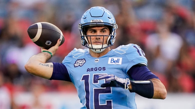 A men's football quarterback attempts a pass.