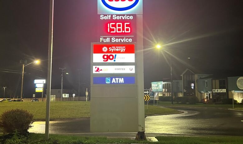 Sign showing the price of gas at night.