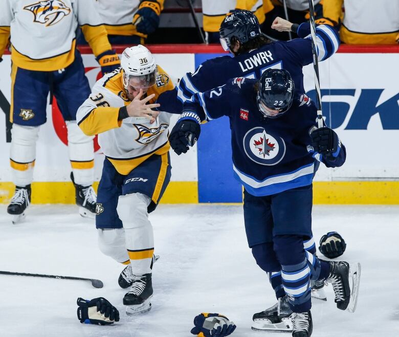 Two hockey players square off in a fight