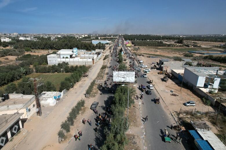 An aerial view showing Palestinian civilians heading along the Salah Al-Din road in the Wadi Gaza district of the Gaza Strip.