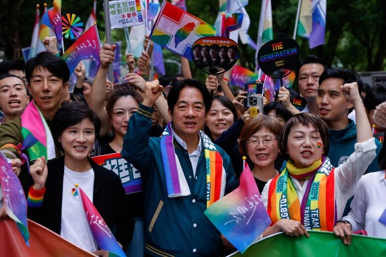 Group of people with rainbow scarves