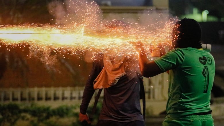 Demonstrators clash with riot police during a protest against a Canadian mining company in Panama.