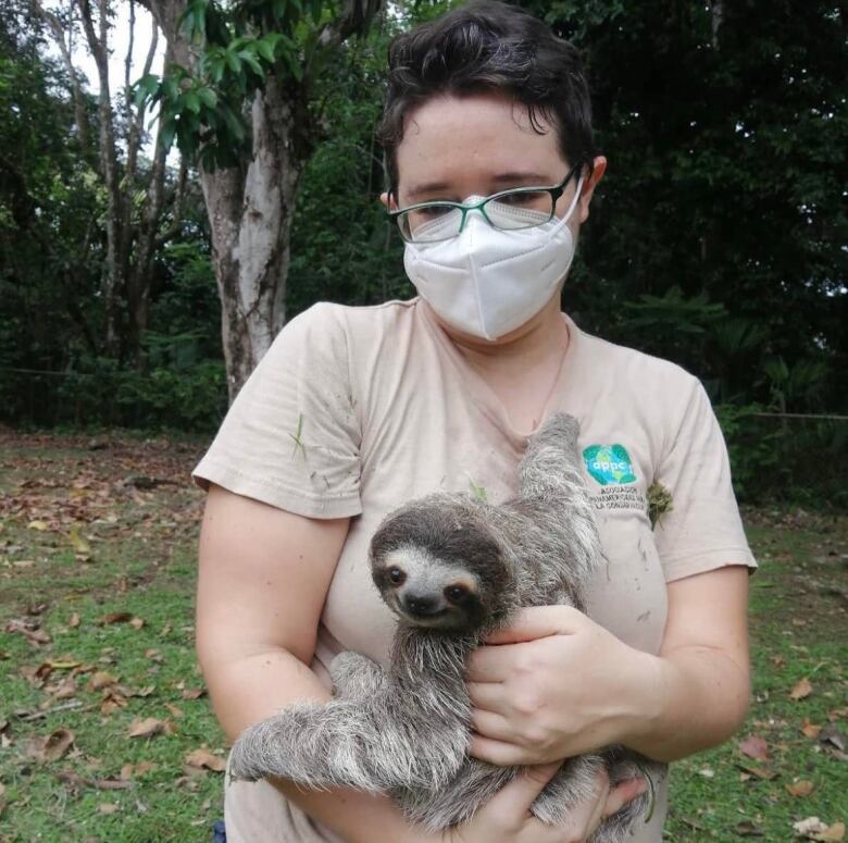 Kitty Quitmeyer holding a sloth.