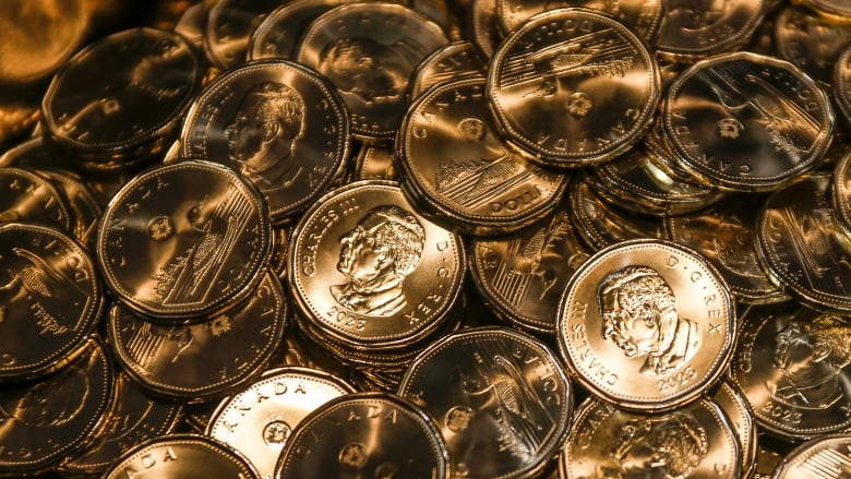 Numerous newly-minted coins are shown displaying the effigy of King Charles.