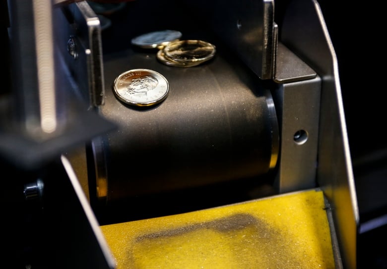 Numerous newly-minted coins are shown displaying the effigy of King Charles.