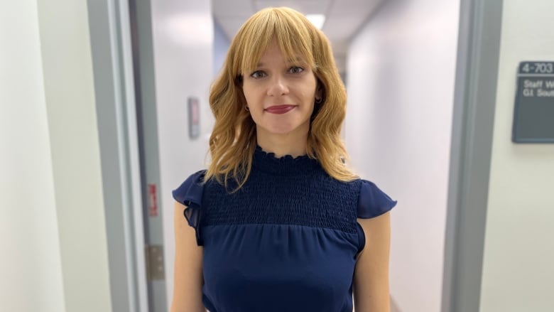 Katy Kosyachkova is pictured standing in a hospital hallway at Princess Margaret Cancer Centre.