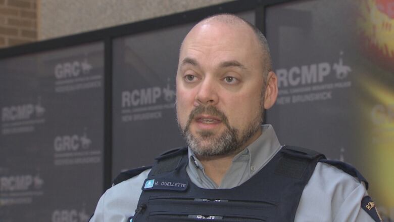 Hans Ouellette speaks inside the New Brunswick RCMP headquarters in Fredericton.