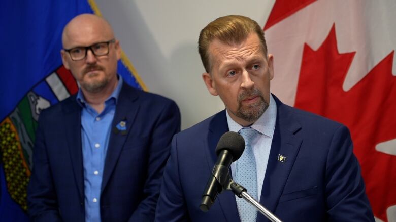  Minister of public safety and emergency services Mike Ellis, right, announces a new SCAN unit in Lethbridge alongside its mayor Blaine Hyggen, left, one of the initiative's partners. 