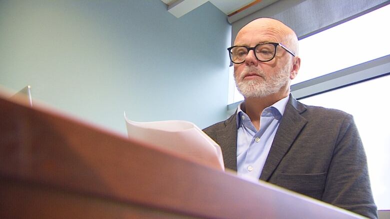 Health P.E.I. CEO Dr. Michael Gardam sitting at desk.