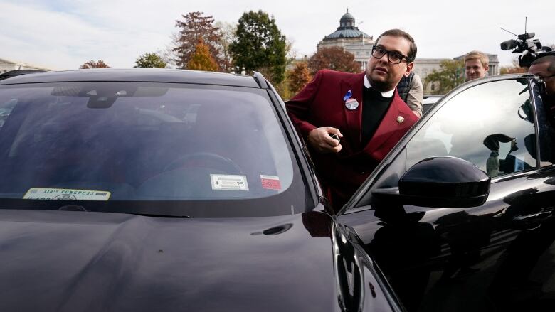 George Santos is seen leaving the U.S. Capitol on Wednesday.