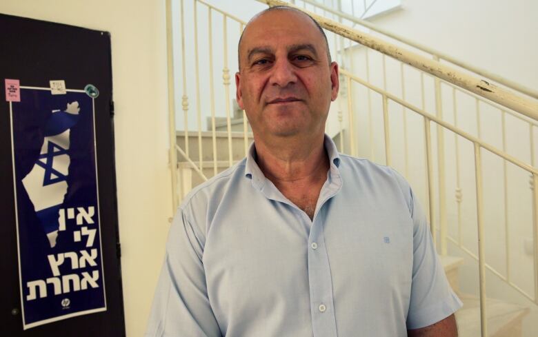 Shalom Ben Hanan, who worked for more than two decades with the Israeli Security Agency, stands in stairwell.