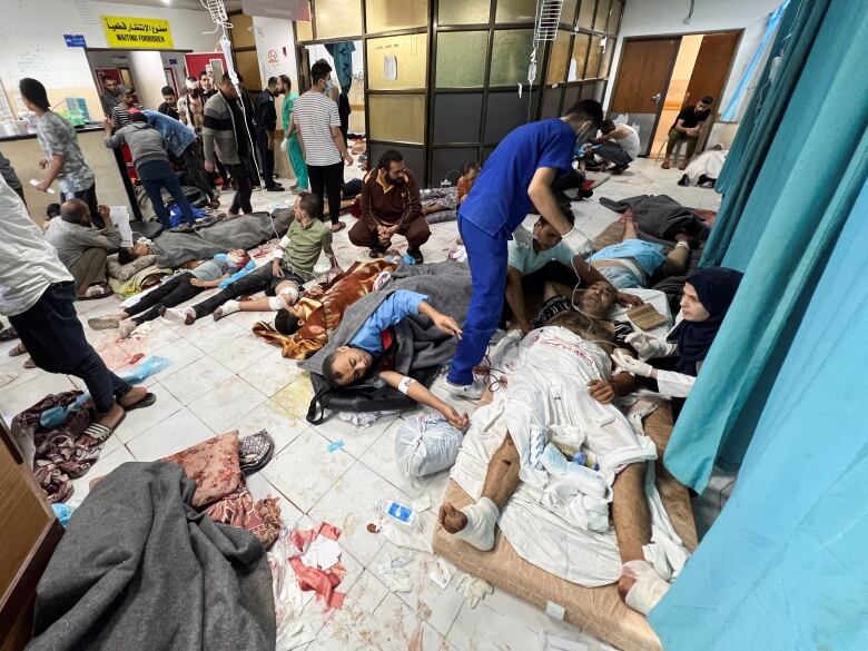 Palestinians wounded in Israeli strikes lie on the floor as they are assisted at the Indonesian hospital after Al Shifa hospital has gone out of service amid Israeli ground offensive, in the northern Gaza Strip November 16, 2023.