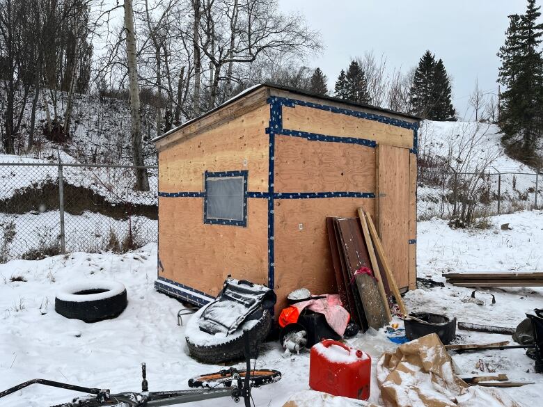 Plywood structure with items surrounding it