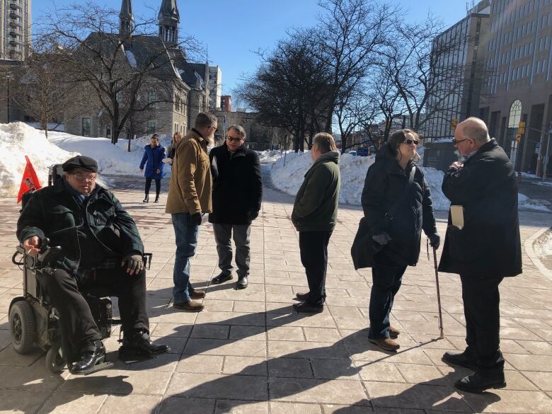 John Cody and other survivors and supporters gather outside the Ottawa courthouse on March 1, 2019 after the second conviction of former Bell High School teacher, Bob Clarke. 