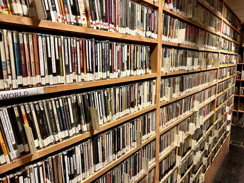 A wall of shelves filled with CDs and LPs.