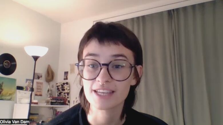 A Zoom screen capture showing an individual with glasses.