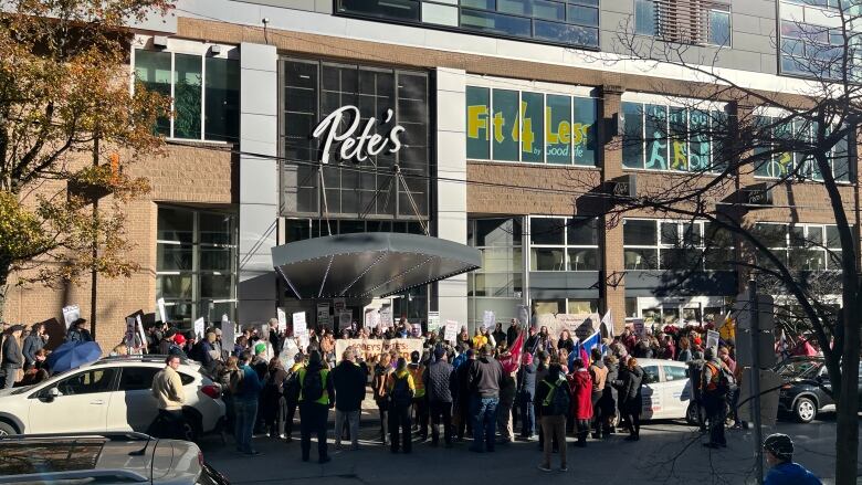 A rally in front of a supermarket.