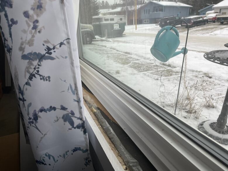 A close-up of a damaged window frame.