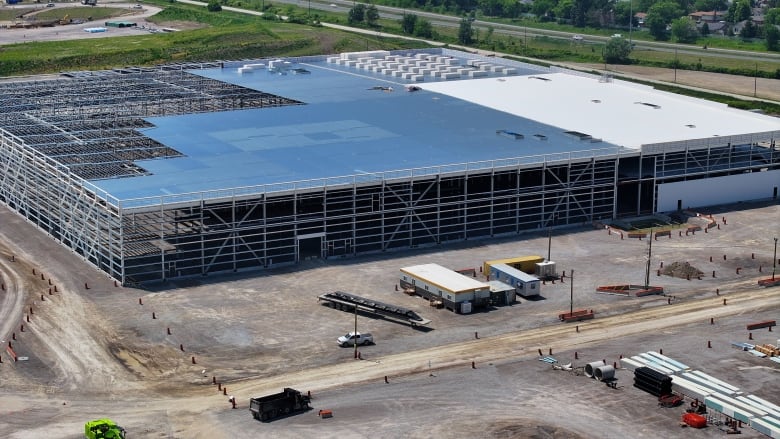 An aerial view of large industrial buildings under construction.