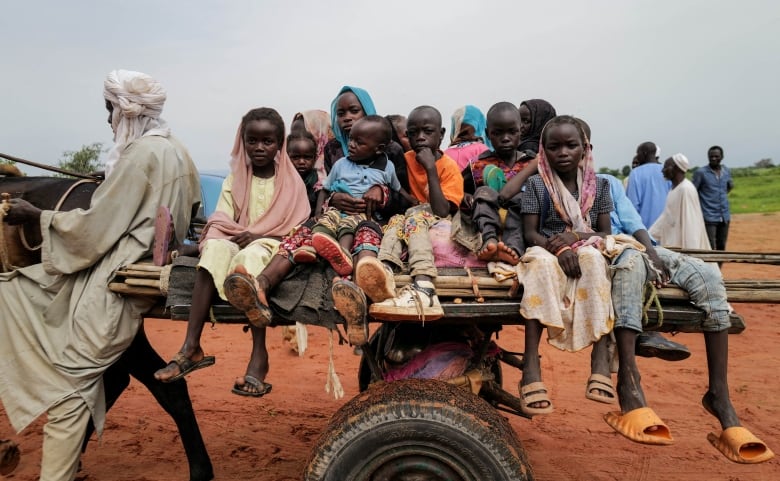 Sudanese children, who fled the conflict in Murnei in Sudan's Darfur region, ride a cart while crossing  the border between Sudan and Chad in Adre, Chad August 4, 2023. 