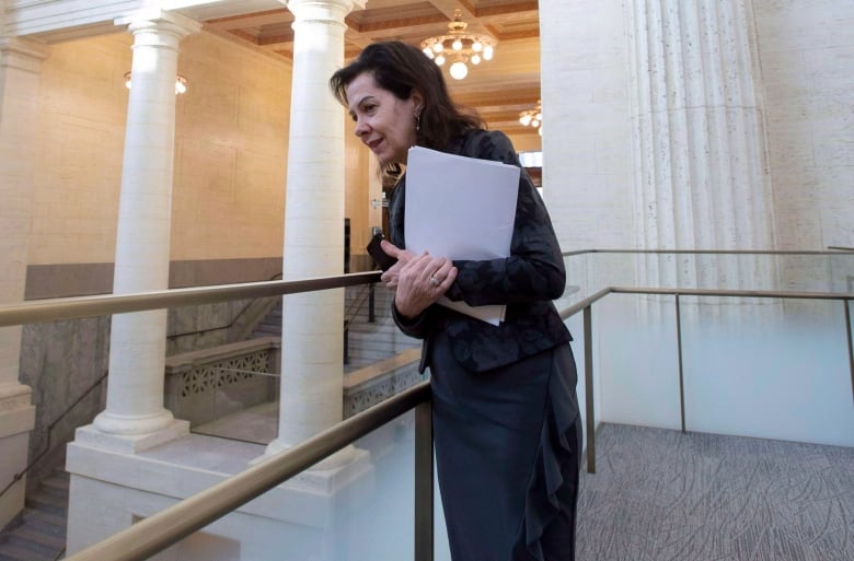 Sen. Raymonde Saint-Germain looks into the Main Hall at the Senate of Canada Building, formerly the Government Conference Centre, is shown in Ottawa.