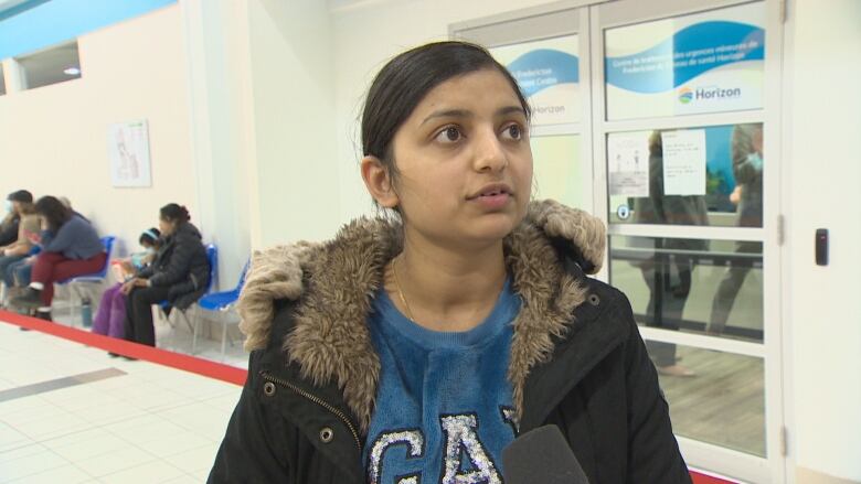 Rupinder Kaur speaks outside Horizon Health Network's urgent treatment centre.